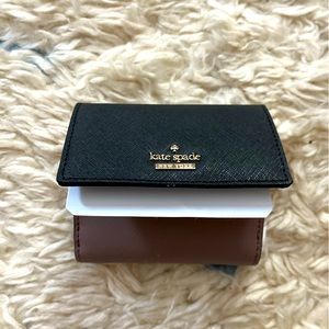 Kate Spade wallet. Unused with protective foam and tags.